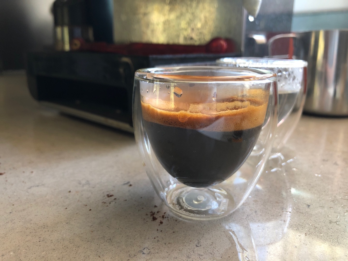 Espresso in a small clear glass cup 
