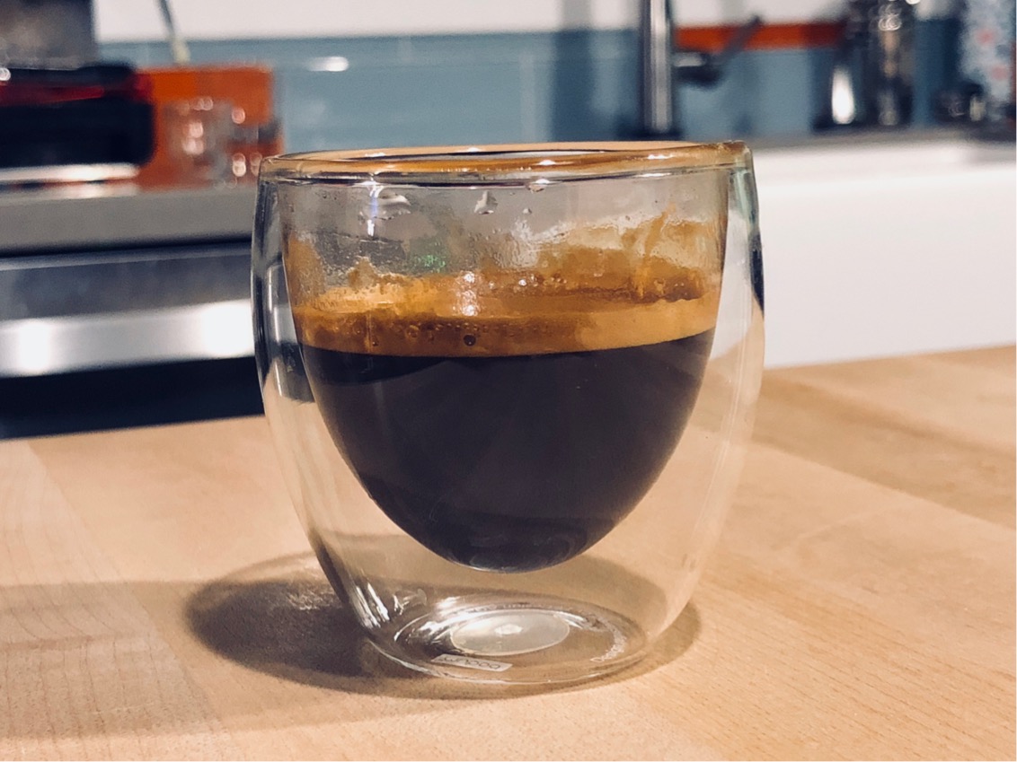 Espresso in a glass cup on kitchen counter  