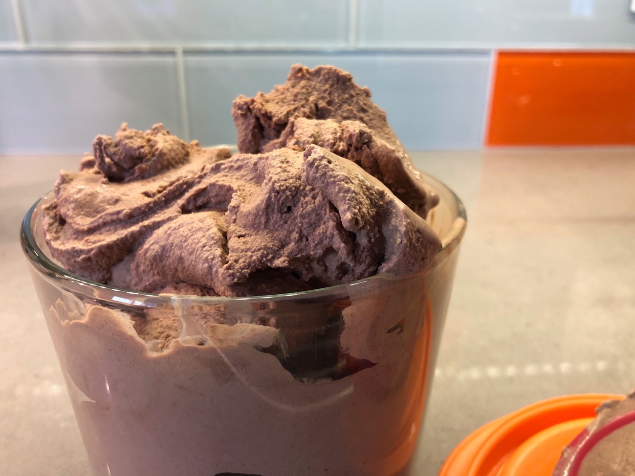 Photo of a container of soft chocolate ice cream 