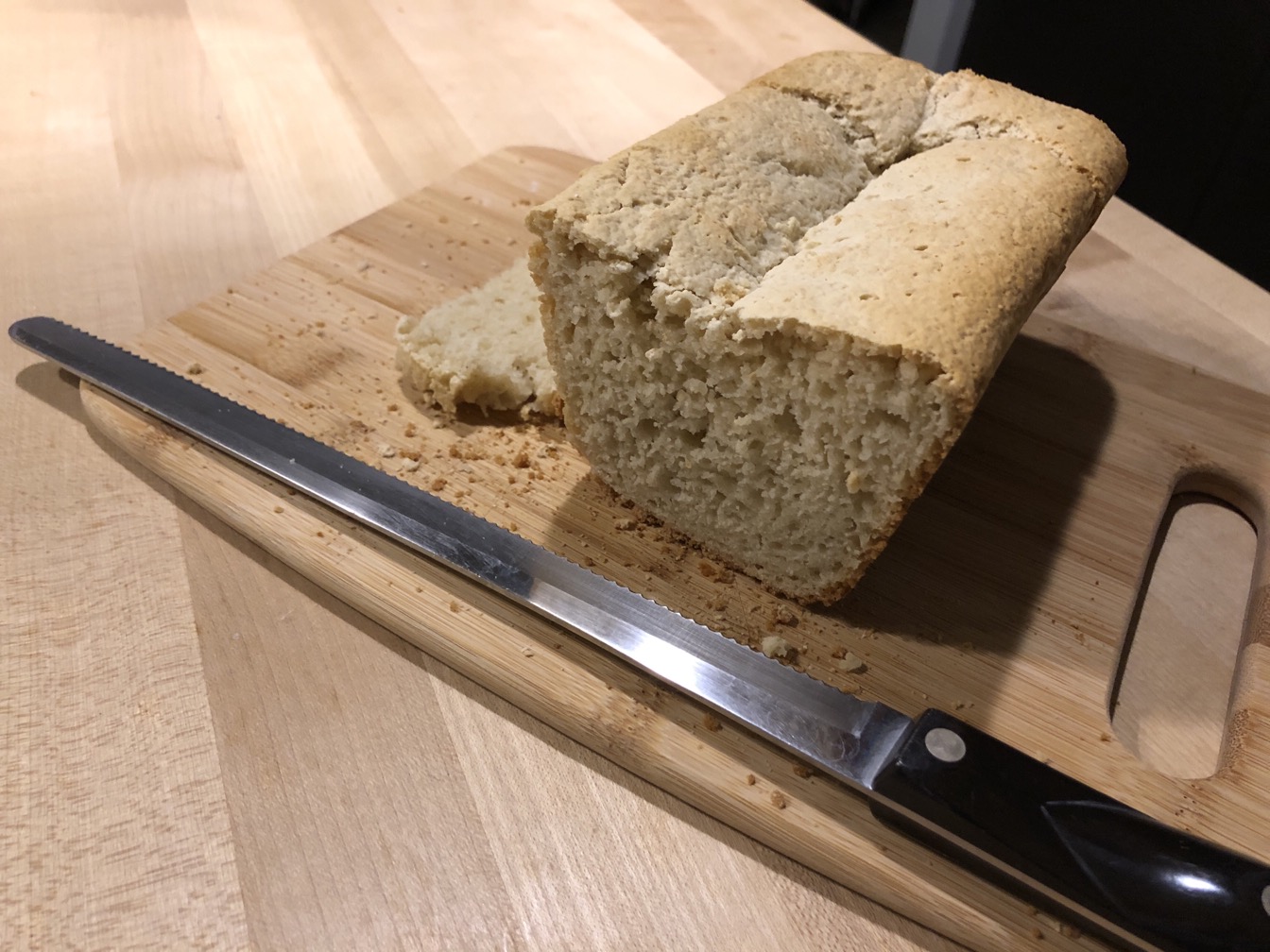 Photo of a sliced loaf of bread on a cutting board  